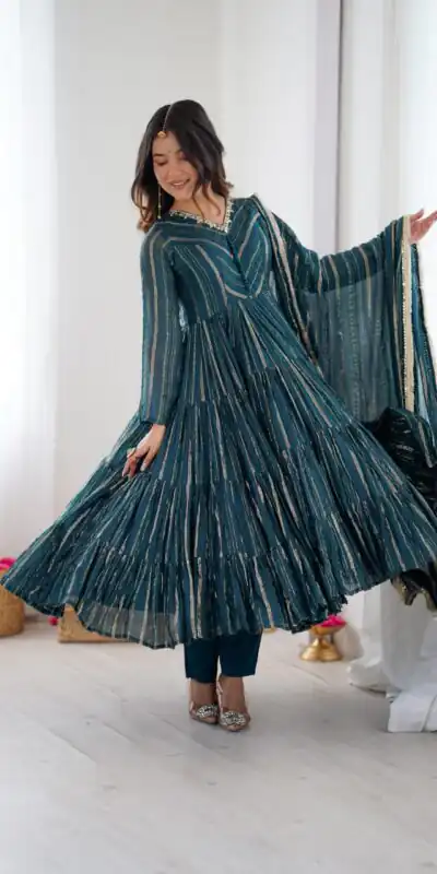 SRK 5305 Peacock Blue Color Mal Chanderi Gown with Mirror Work & Lace Work. Grab it for ₹2399. Delivery 4-6 Working Days. Shop now. | Bollywood Gowns, Creative Gowns, Designer Gowns, Embroidered Gowns, Gowns, Party Wear Gowns