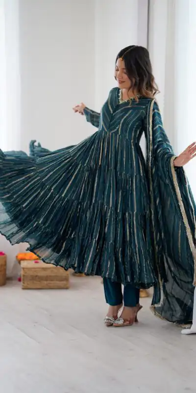 SRK 5305 Peacock Blue Color Mal Chanderi Gown with Mirror Work & Lace Work. Grab it for ₹2399. Delivery 4-6 Working Days. Shop now. | Bollywood Gowns, Creative Gowns, Designer Gowns, Embroidered Gowns, Gowns, Party Wear Gowns