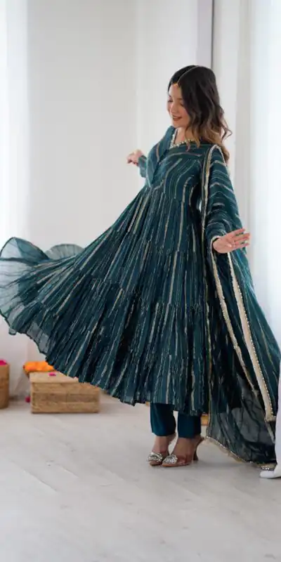 SRK 5305 Peacock Blue Color Mal Chanderi Gown with Mirror Work & Lace Work. Grab it for ₹2399. Delivery 4-6 Working Days. Shop now. | Bollywood Gowns, Creative Gowns, Designer Gowns, Embroidered Gowns, Gowns, Party Wear Gowns