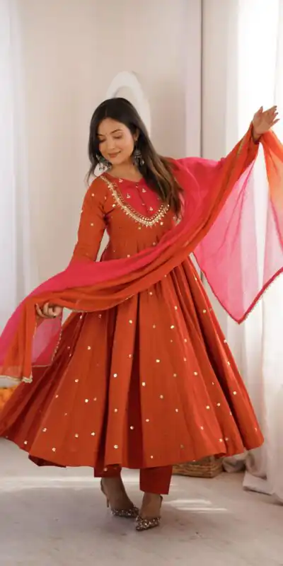 ZF 5023 Rust Roman Silk Gown with Mirror Work & Embroidery Work. Special Price ₹2099. Delivery 4-6 Working Days. Shop now. | Bollywood Gowns, Creative Gowns, Designer Gowns, Embroidered Gowns, Gowns, Party Wear Gowns